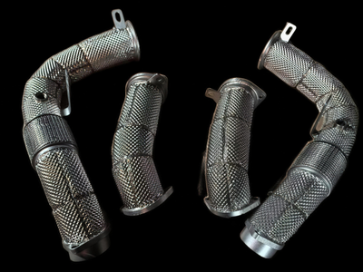 BMW XM G09 S68 catless and high-flow downpipes on black background — YPG Motorsport