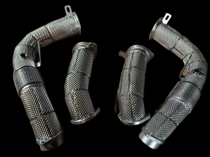 BMW XM G09 S68 catless and high-flow downpipes on black background — YPG Motorsport